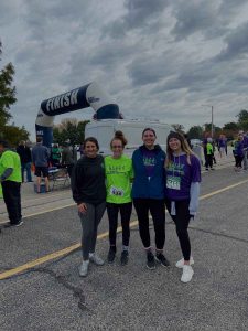 4 BIFSTL runners pose at the finish line of the Stampede for Stroke run
